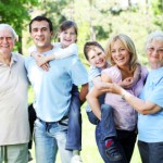 Extended happy family standing in the park.